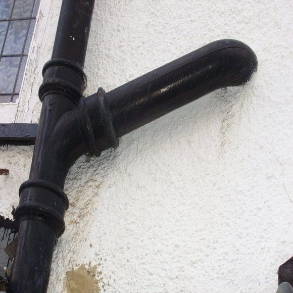 cast iron soil pipe installed on house exterior